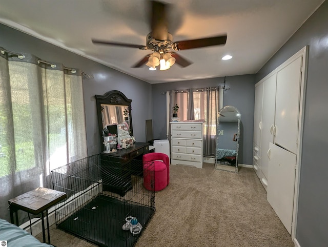 interior space with ceiling fan and carpet