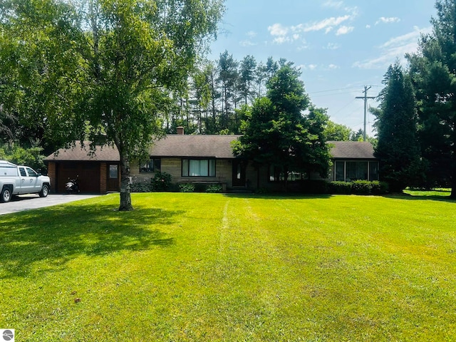 view of front of house with a front lawn and a garage