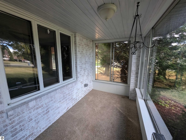 unfurnished sunroom featuring wood ceiling