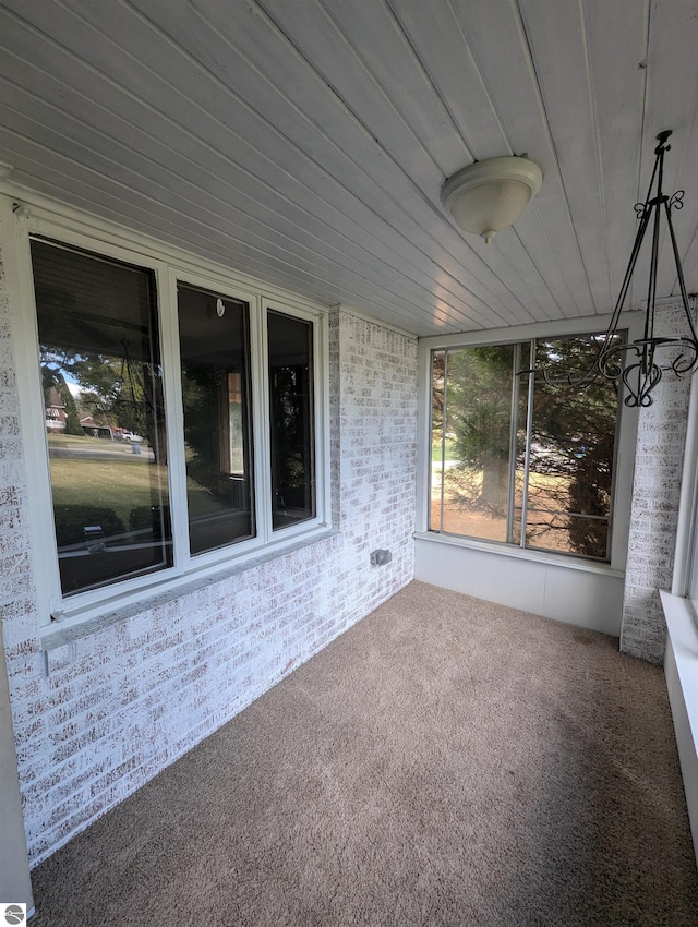 unfurnished sunroom featuring wooden ceiling