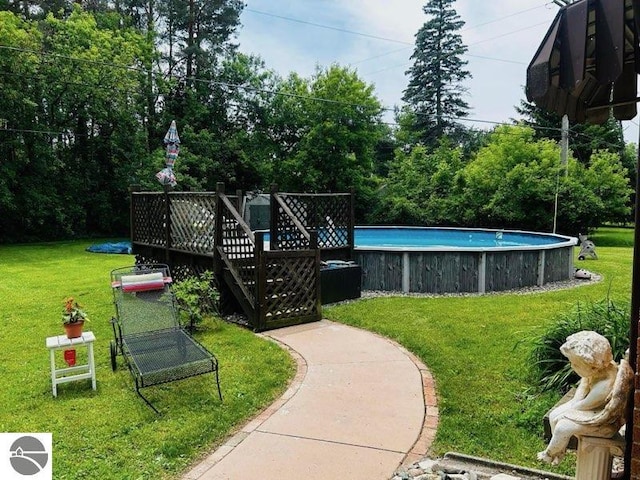 exterior space featuring a pool and a yard