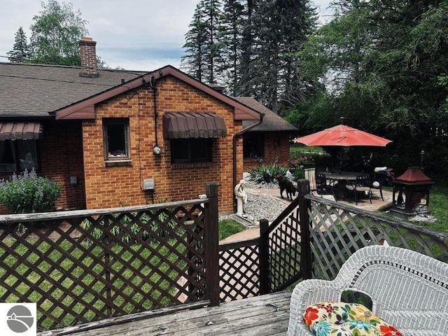 wooden terrace featuring a patio