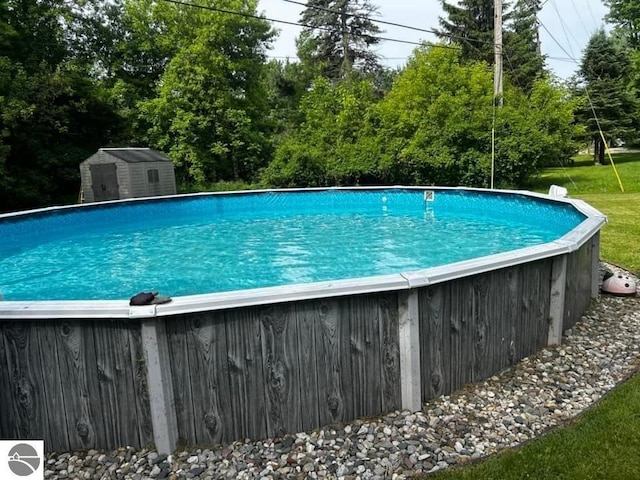 view of pool with a storage unit