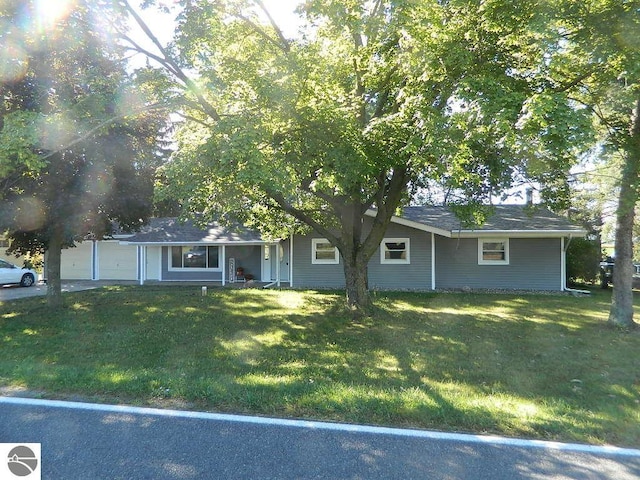 single story home with a front yard and a garage