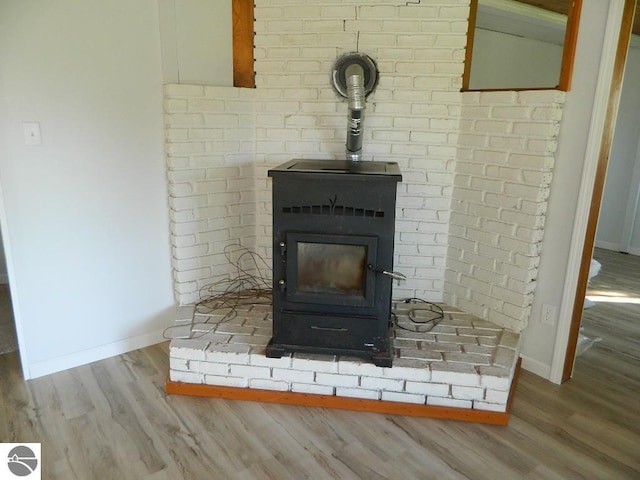 room details featuring hardwood / wood-style flooring and a wood stove