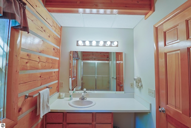 bathroom featuring walk in shower and vanity