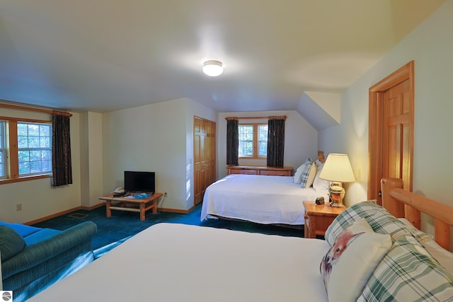 carpeted bedroom featuring multiple windows