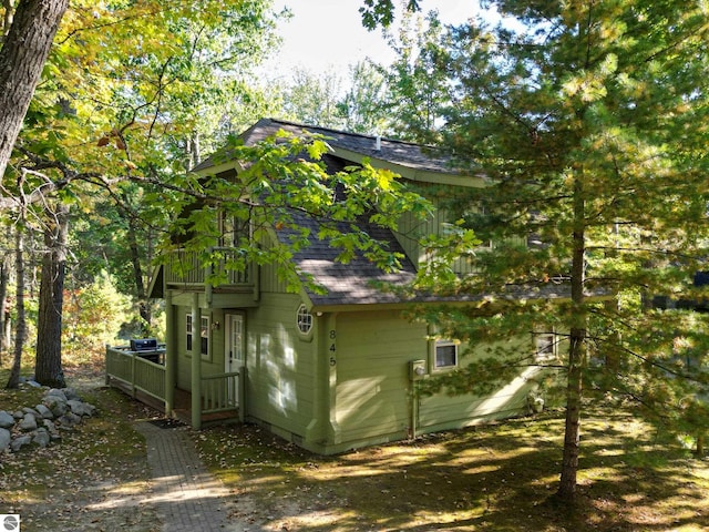 view of side of property with a balcony