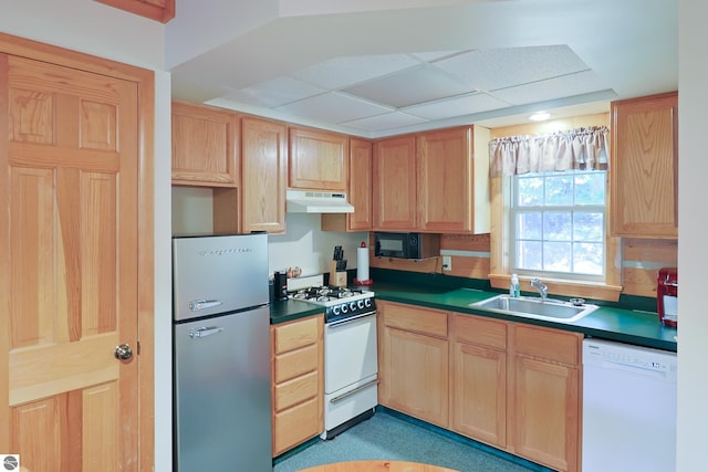 kitchen featuring a paneled ceiling, sink, and white appliances