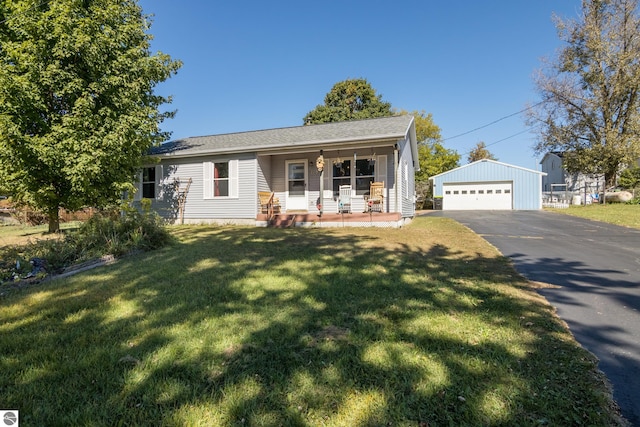 single story home featuring a garage, a front lawn, covered porch, and an outbuilding