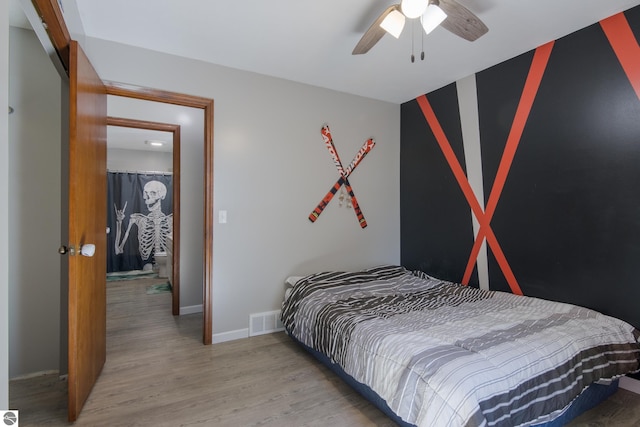 bedroom with ceiling fan, light hardwood / wood-style flooring, and a closet