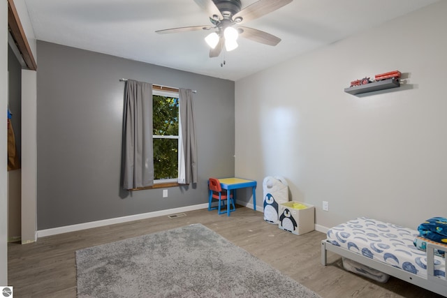 bedroom featuring ceiling fan and wood-type flooring