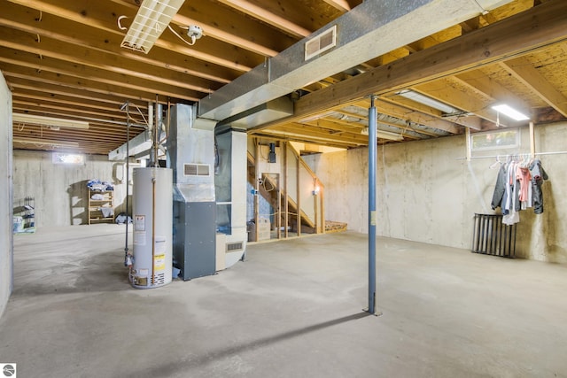 basement with gas water heater and heating unit