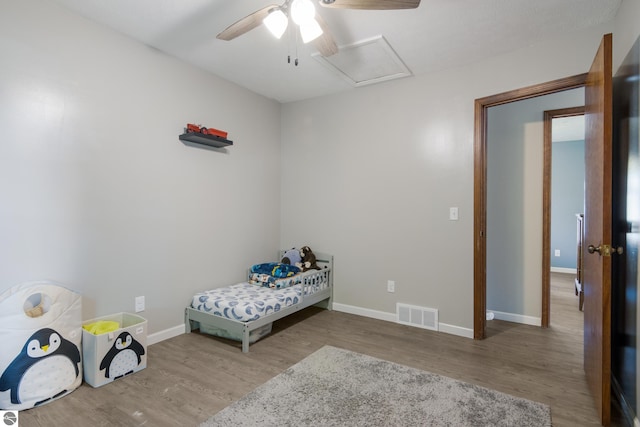 bedroom with wood-type flooring and ceiling fan