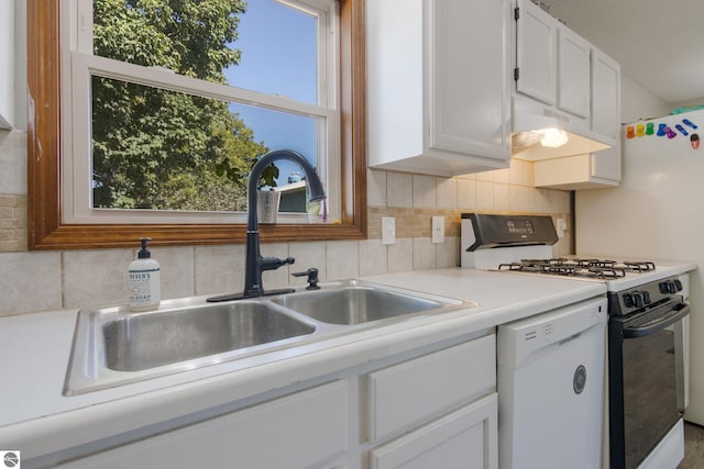 kitchen with a healthy amount of sunlight, sink, white appliances, and white cabinetry