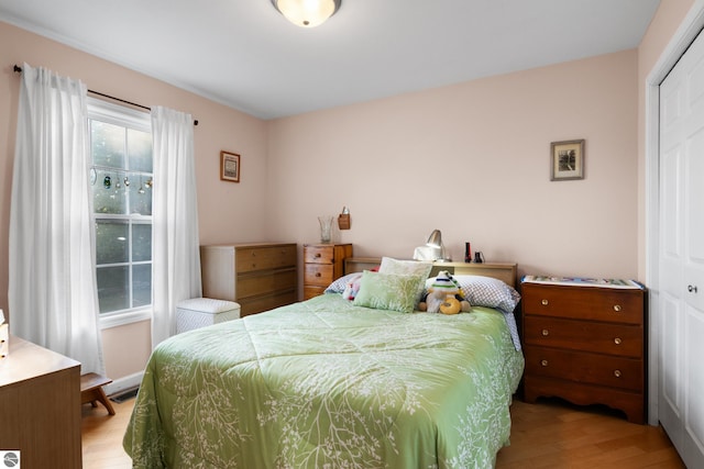 bedroom featuring a closet and light hardwood / wood-style flooring