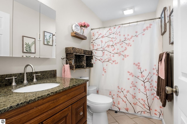 bathroom featuring tile patterned flooring, vanity, curtained shower, and toilet