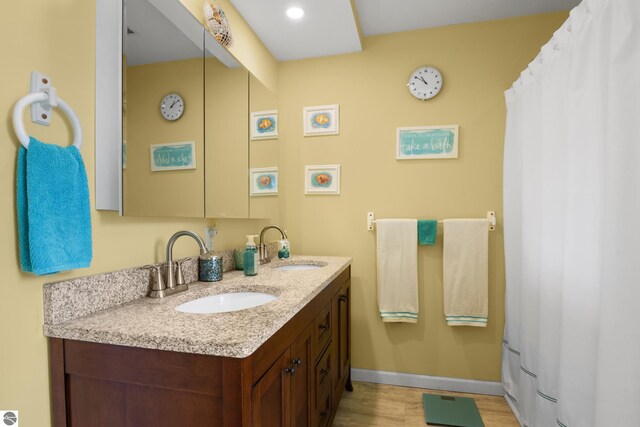 bathroom with vanity and hardwood / wood-style flooring