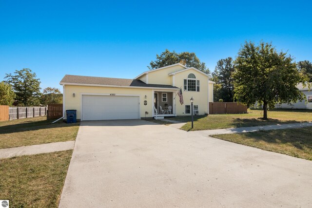 view of front of home with a garage and a front yard