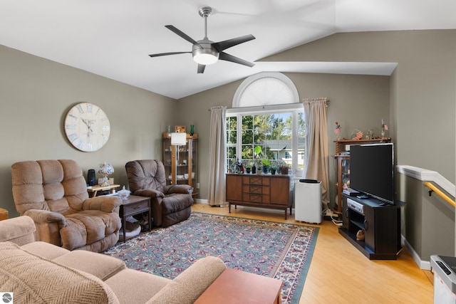 living room with vaulted ceiling, ceiling fan, and light wood-type flooring