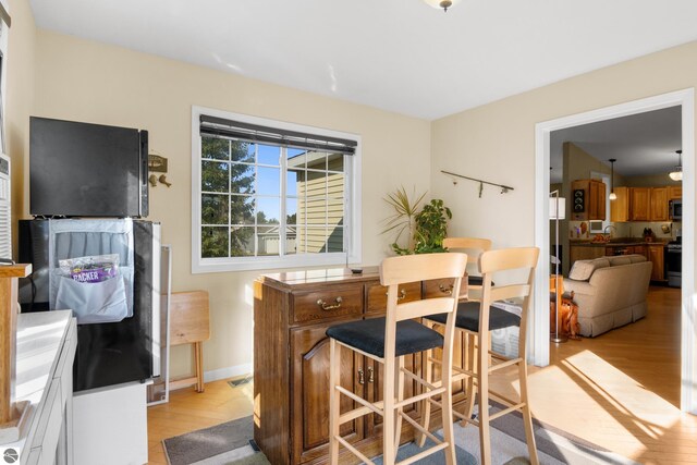 dining space with light hardwood / wood-style floors