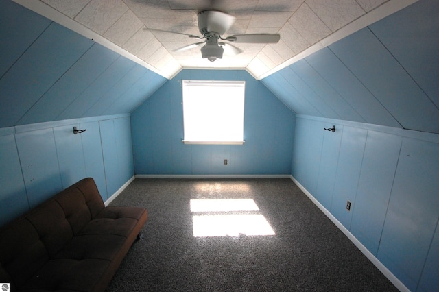 additional living space with carpet flooring, lofted ceiling, and ceiling fan