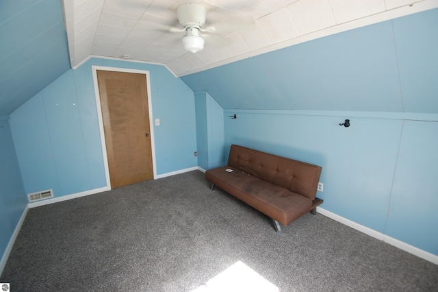 living area featuring carpet floors, vaulted ceiling, and ceiling fan