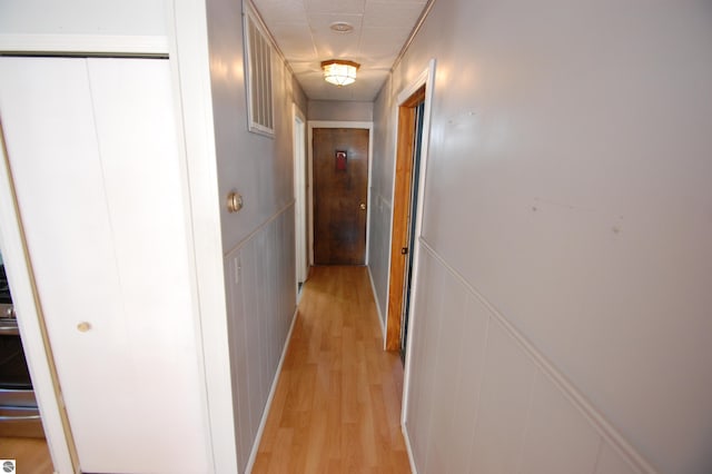 corridor with light hardwood / wood-style flooring