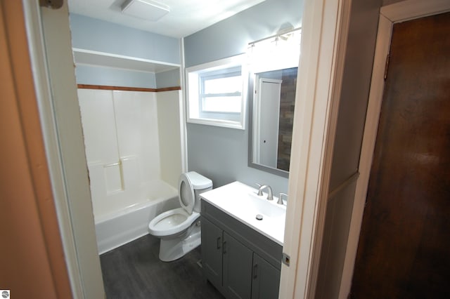 full bathroom with vanity, hardwood / wood-style floors, toilet, and washtub / shower combination