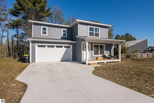 view of front property featuring a front lawn, covered porch, and a garage