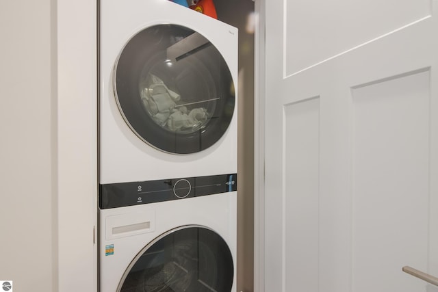 clothes washing area featuring stacked washer / dryer