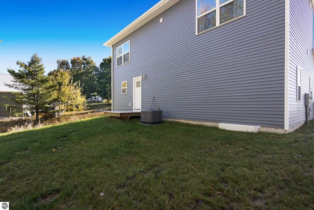 view of home's exterior featuring a lawn and central AC