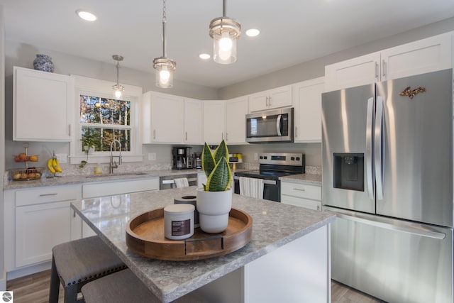 kitchen featuring a kitchen island, stainless steel appliances, and white cabinets