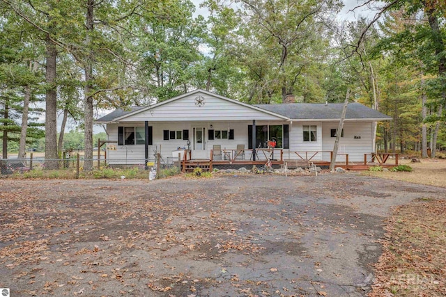 2169 Brady Dr, West Branch, MI 48661 - view of front of house with a porch, a chimney, and fence