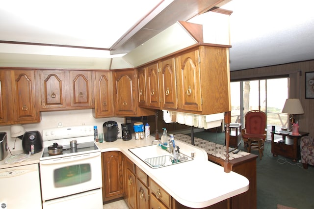 2169 Brady Dr, West Branch, MI 48661 - kitchen with white appliances, a sink, and brown cabinets