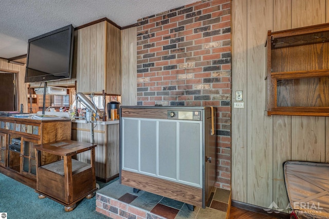 2169 Brady Dr, West Branch, MI 48661 - kitchen with wood walls, a textured ceiling, and ornamental molding