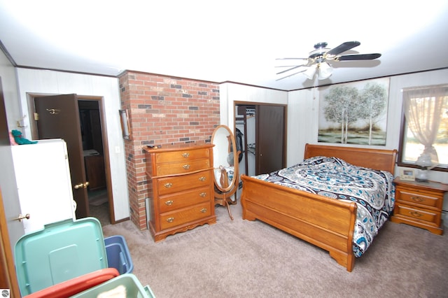 2169 Brady Dr, West Branch, MI 48661 - carpeted bedroom featuring ornamental molding, ceiling fan, and wooden walls