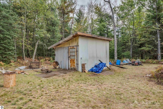 view of outbuilding with a yard