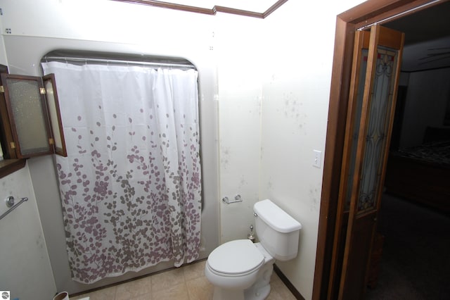 bathroom with a shower with curtain and toilet