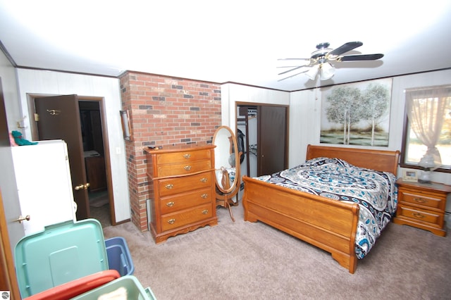 carpeted bedroom featuring a closet, ornamental molding, and ceiling fan