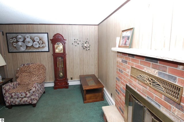 living area with a fireplace, wood walls, dark colored carpet, and a baseboard heating unit