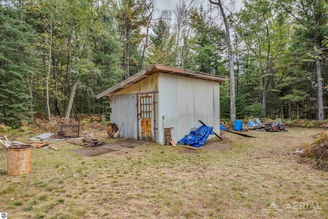 2169 Brady Dr, West Branch, MI 48661 - view of shed featuring a wooded view