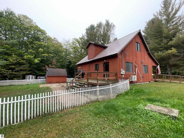 view of home's exterior featuring a yard and a storage unit