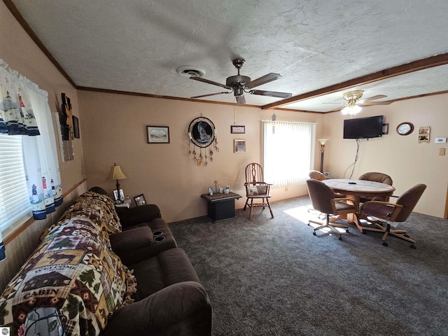 carpeted living room featuring a textured ceiling, ornamental molding, and ceiling fan