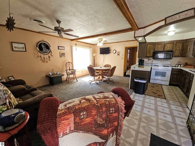 living room with a textured ceiling, beam ceiling, and ceiling fan