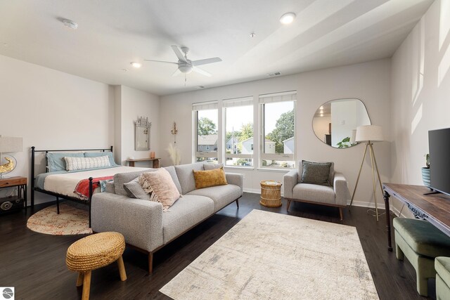 bedroom with ceiling fan and dark hardwood / wood-style flooring