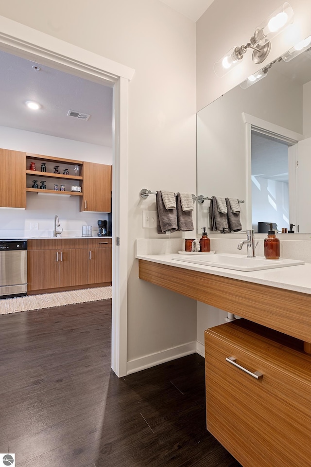630 S Garfield, Traverse City, MI 49686 - bathroom with visible vents, baseboards, a sink, and wood finished floors