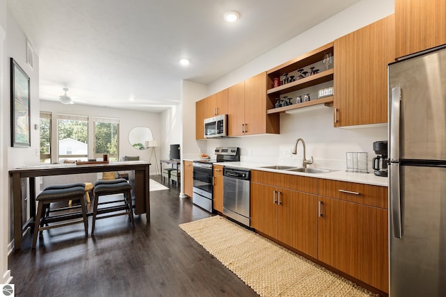 630 S Garfield, Traverse City, MI 49686 - kitchen featuring dark wood finished floors, open shelves, appliances with stainless steel finishes, light countertops, and a sink