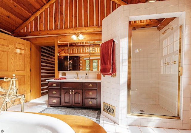 bathroom with tile patterned flooring, vanity, lofted ceiling, and a shower with shower door