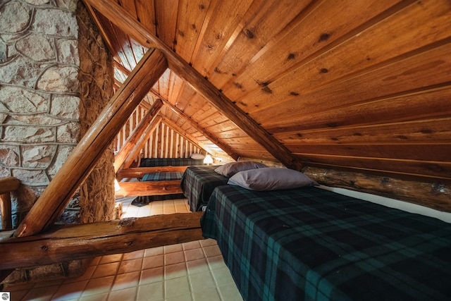 tiled bedroom with wood ceiling, lofted ceiling, and wood walls